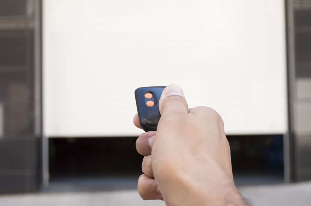 Hand PreQCssing Remote For Garage Door — Garage Doors in Tweed Coast, NSW