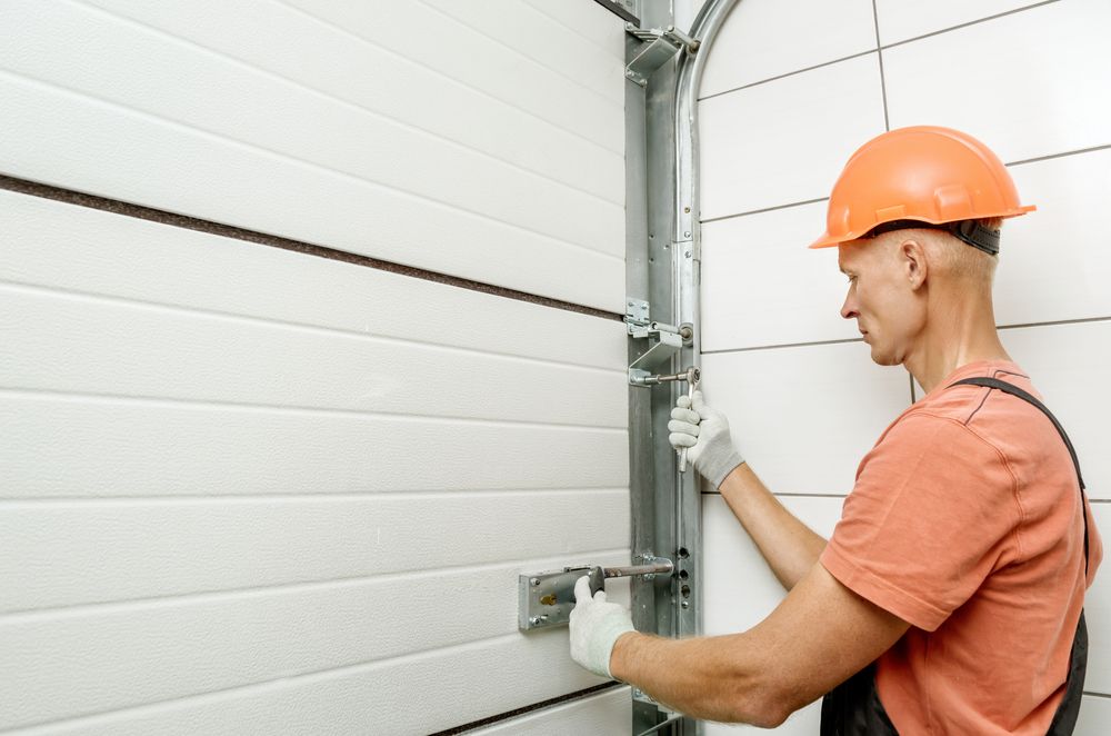 Worker is installing Lift Gates — Garage Doors in Pottsville, NSW